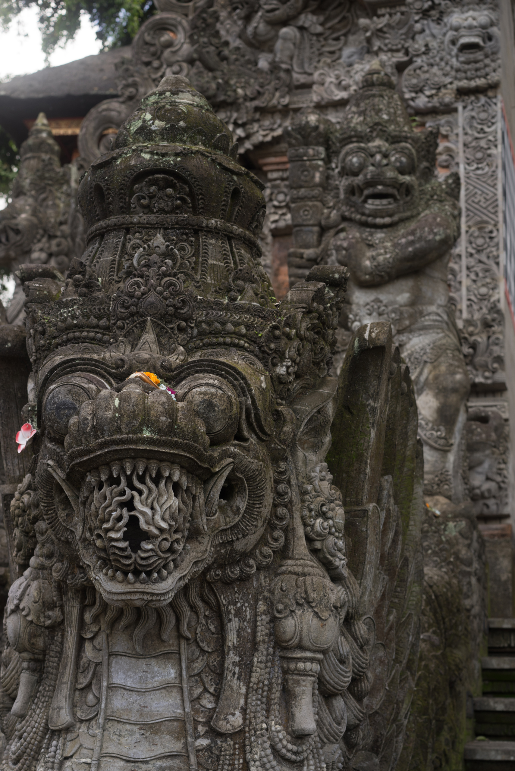 A dragon with a mouthful of fire guarding the stairway into the temple