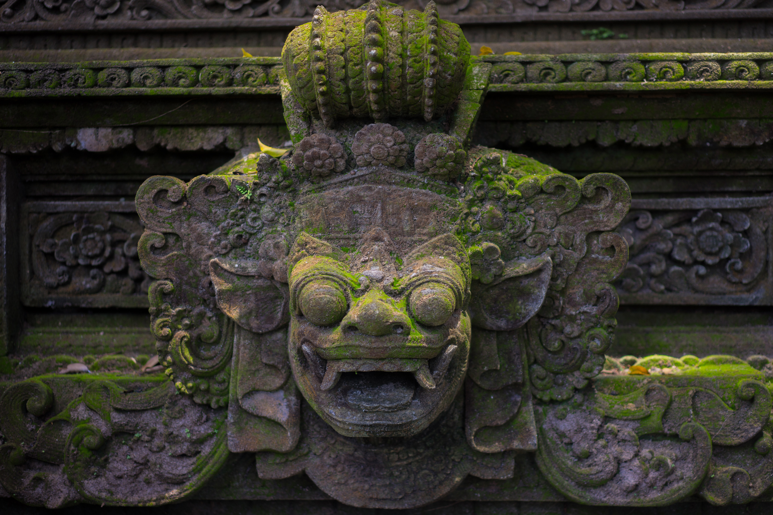 Lichen covered Barong faces were all over the walls of the temple