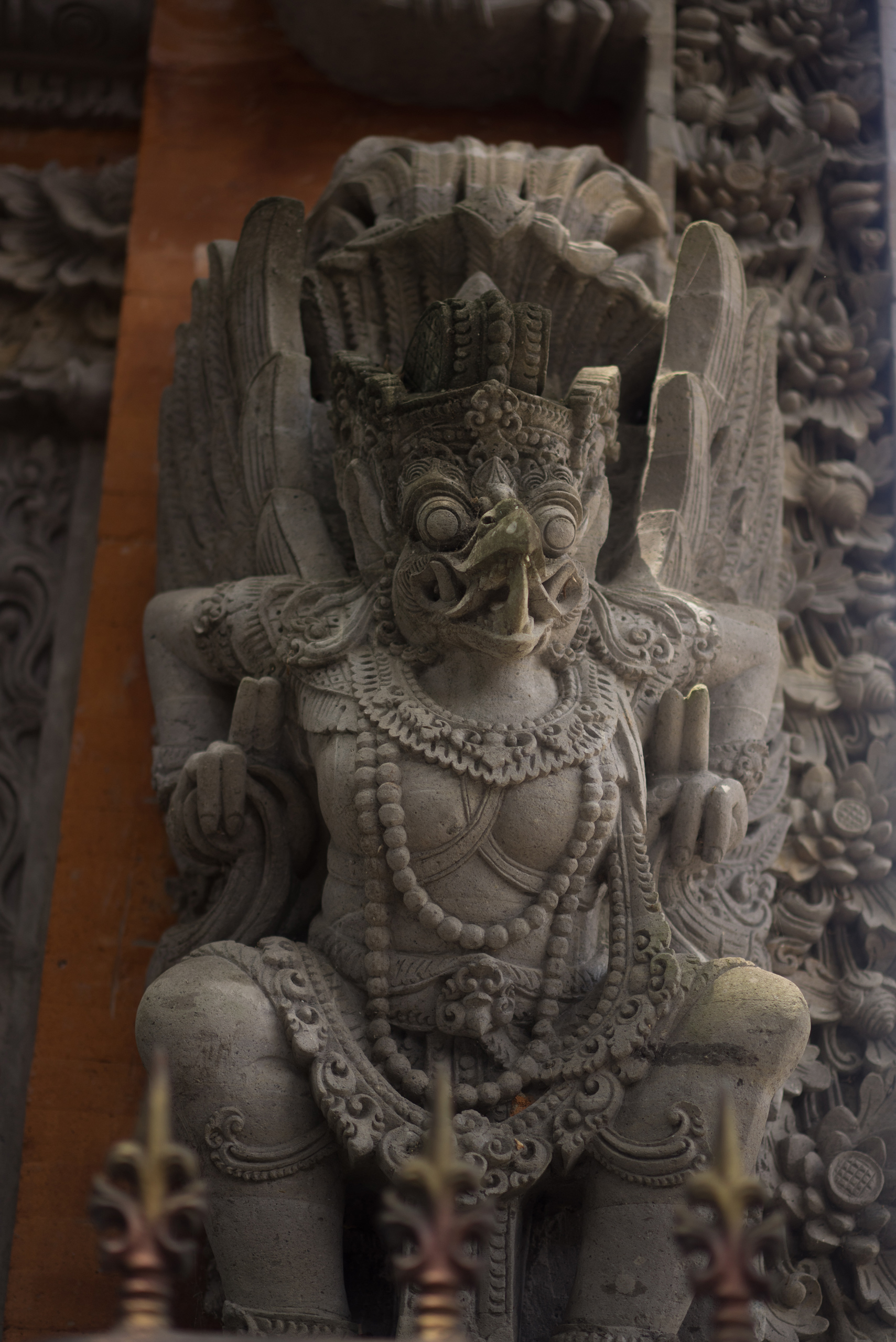 A Garuda making a gesture while wearing malas and other garb