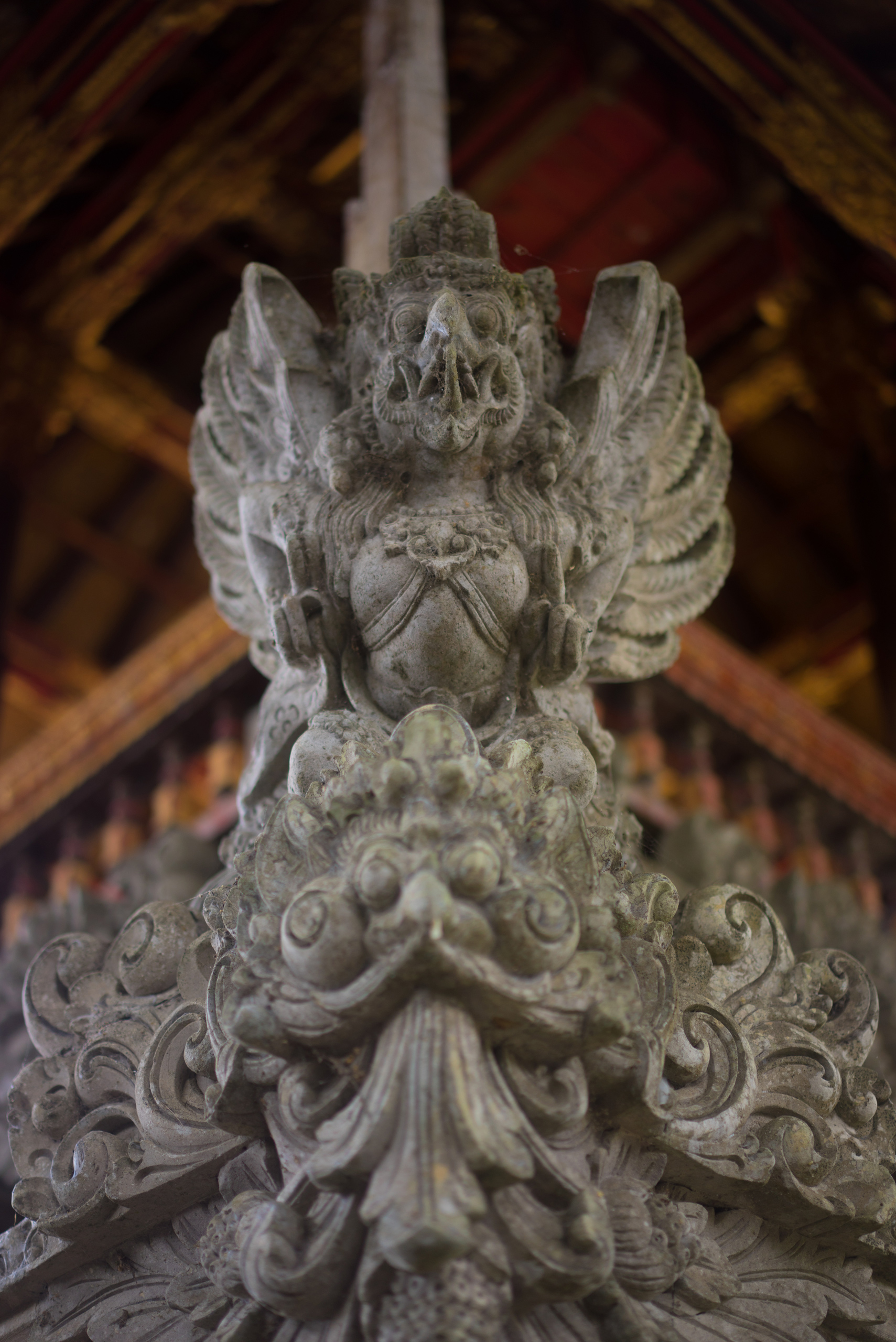 A Garuda points up with two fingers on each hand