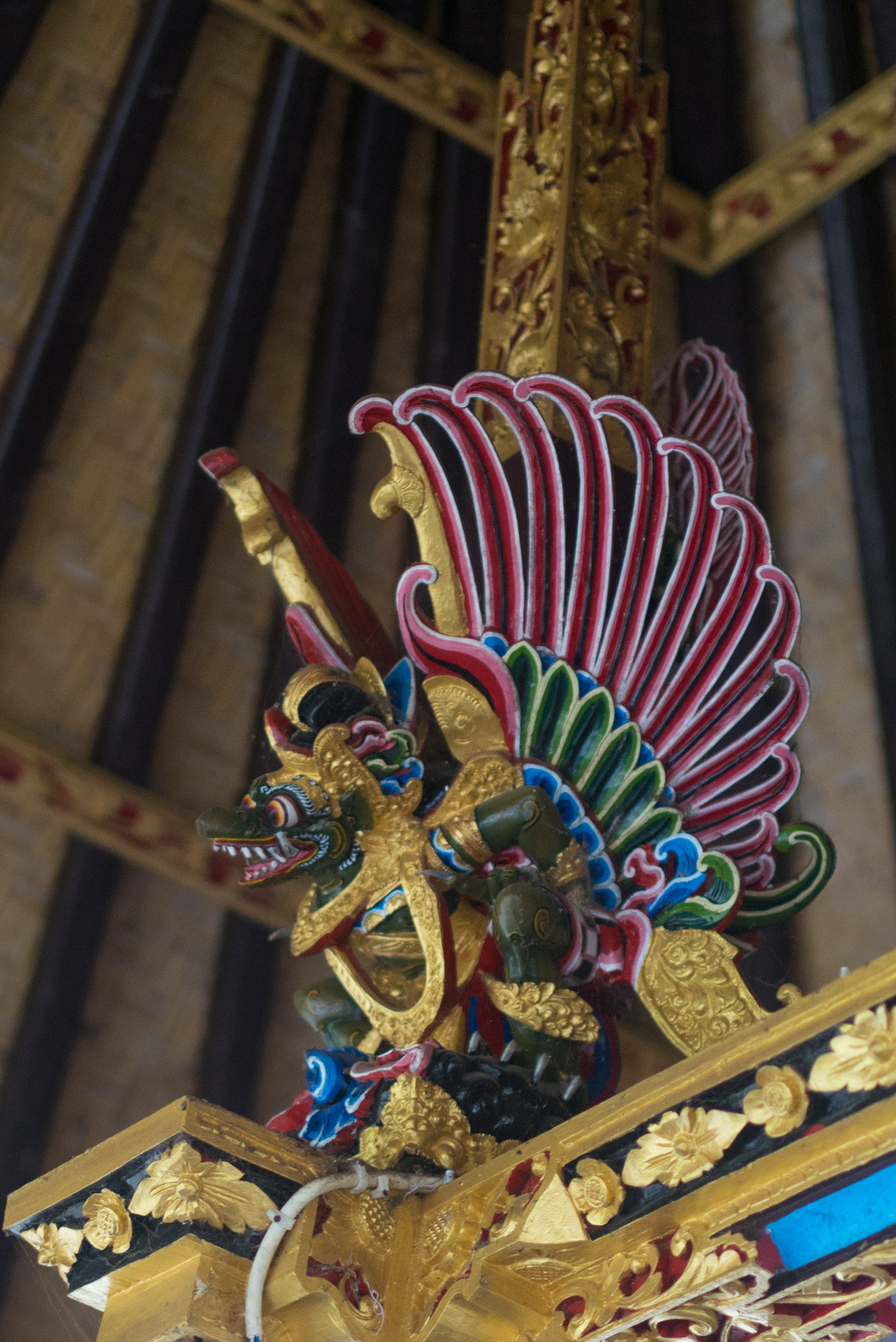 A colorful Gaurda does a little dance for the temple guests
