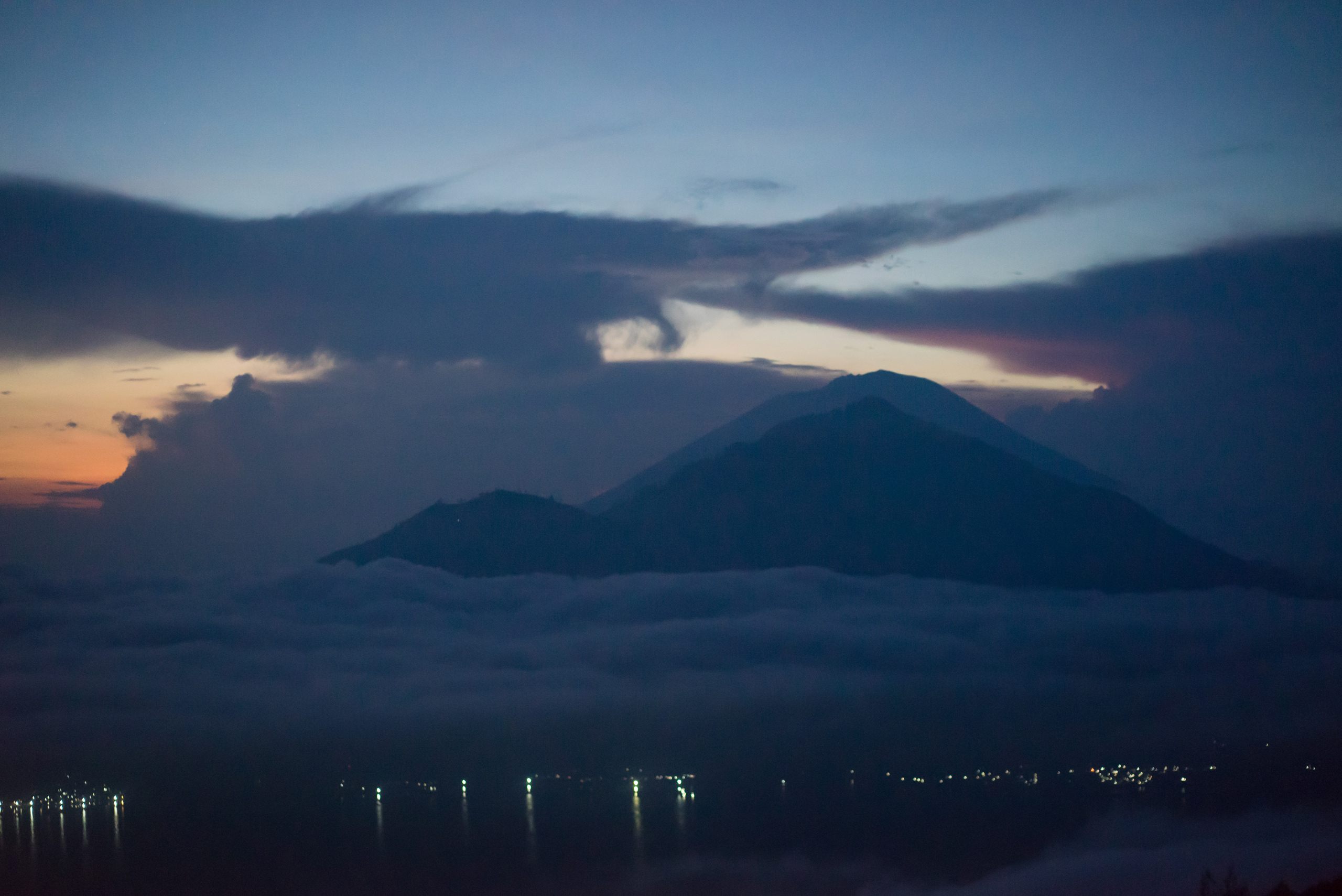 The city below is about to vanish behind the clouds as the sun rises