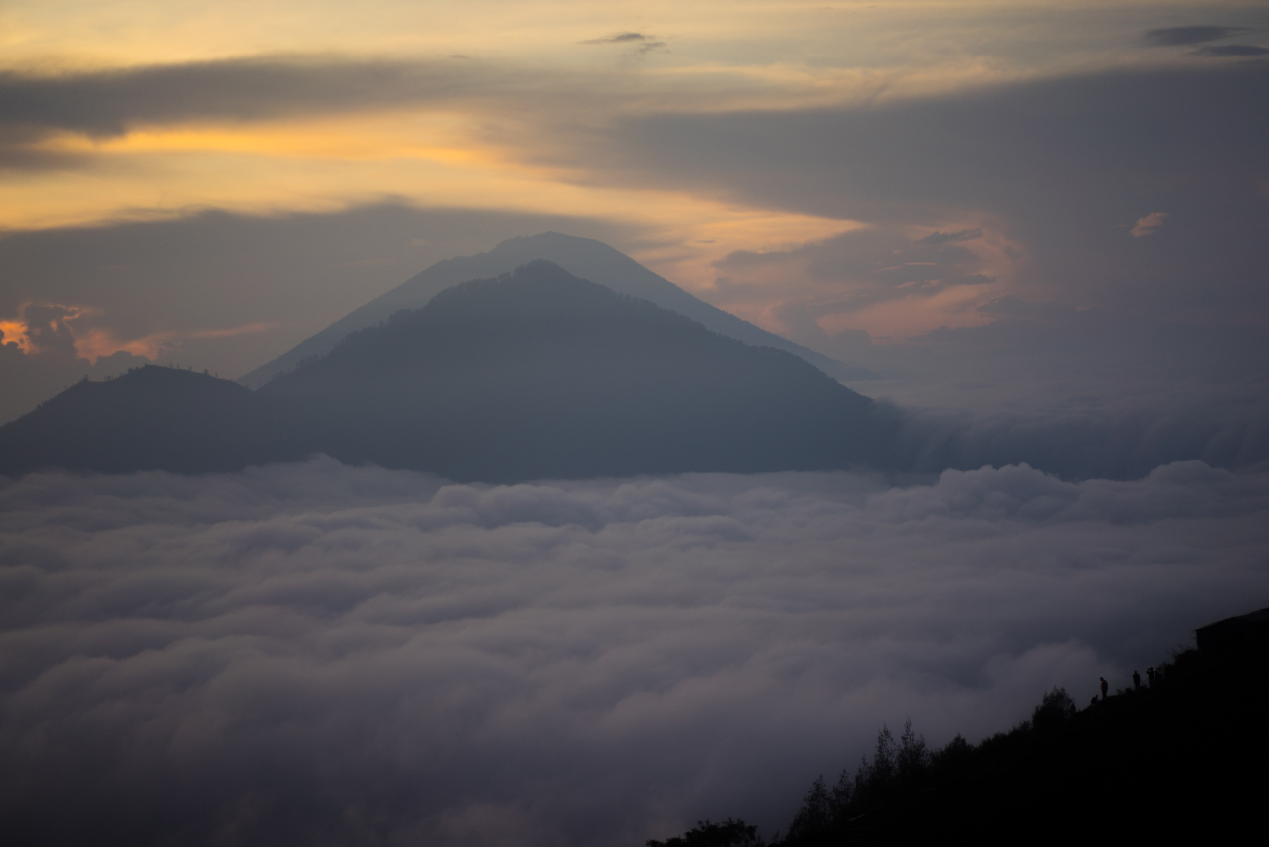 A cloud waterfall over Abang, with Agung seen behind it