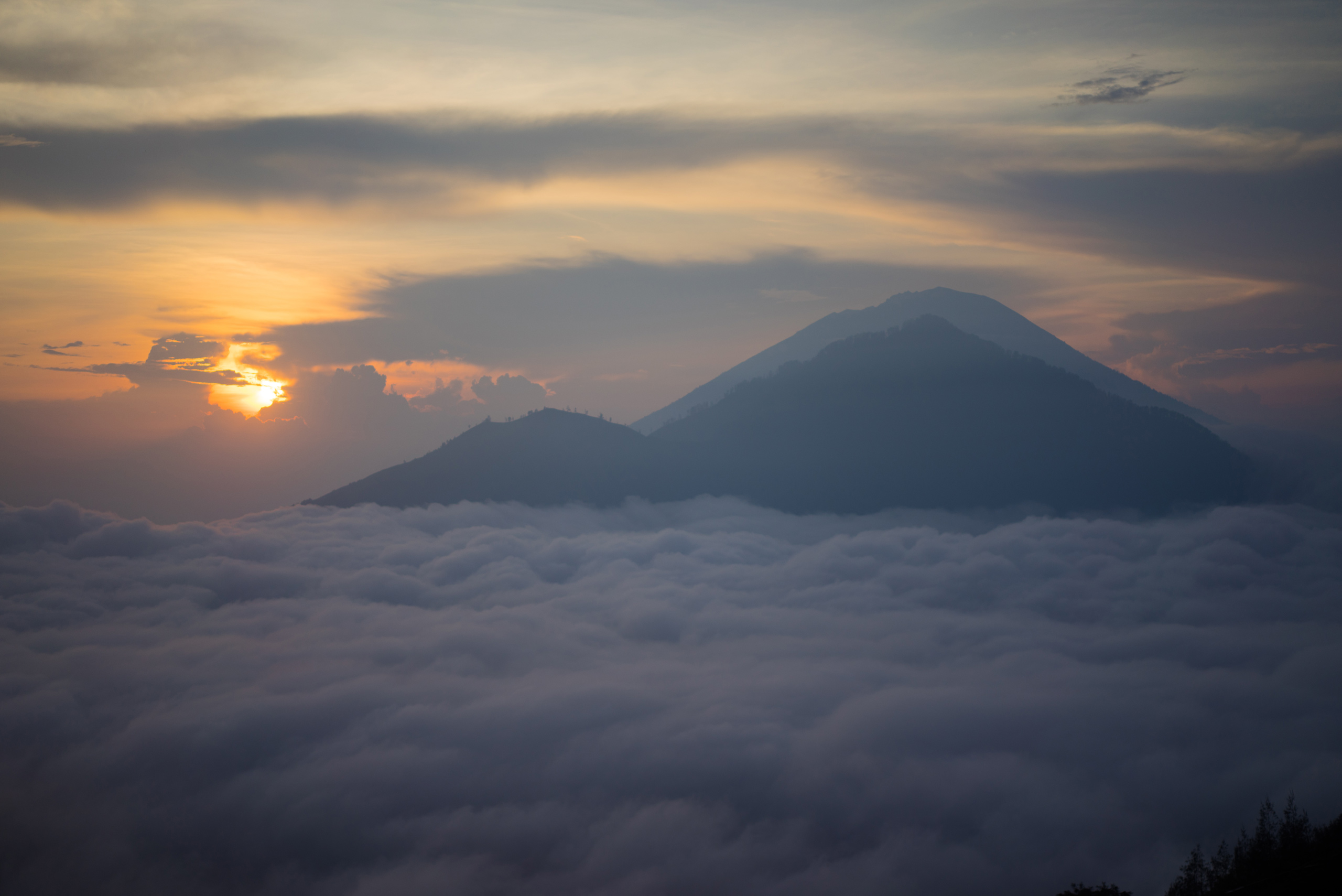 Sunrise viewed from atop Batur, with Abang and Agung seen in the foreground
